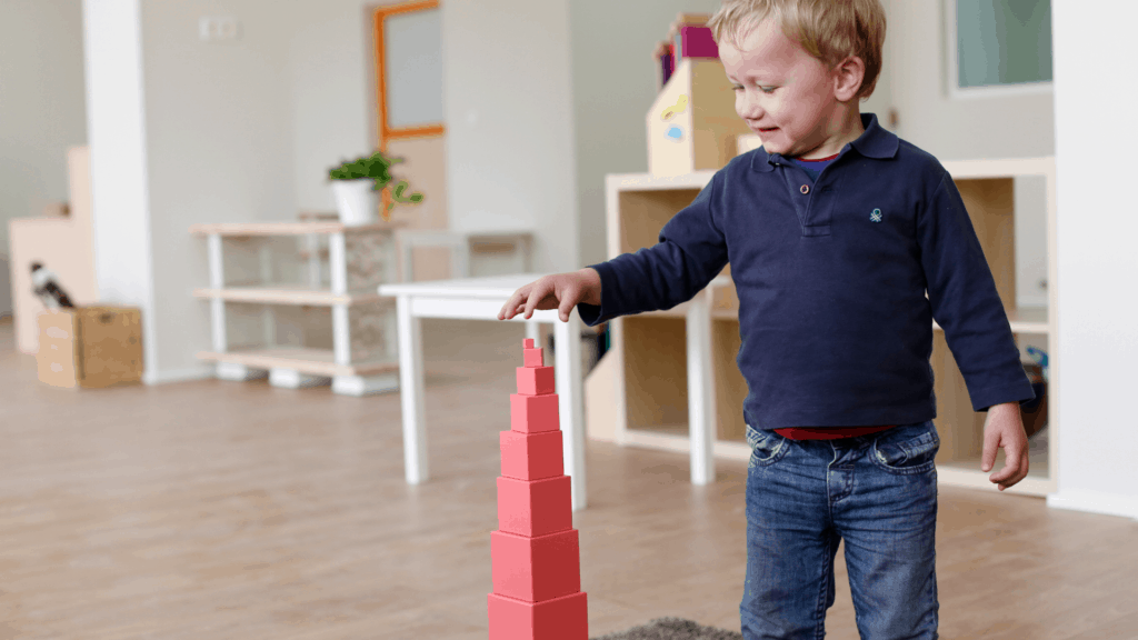 boy playing with The Pink Tower