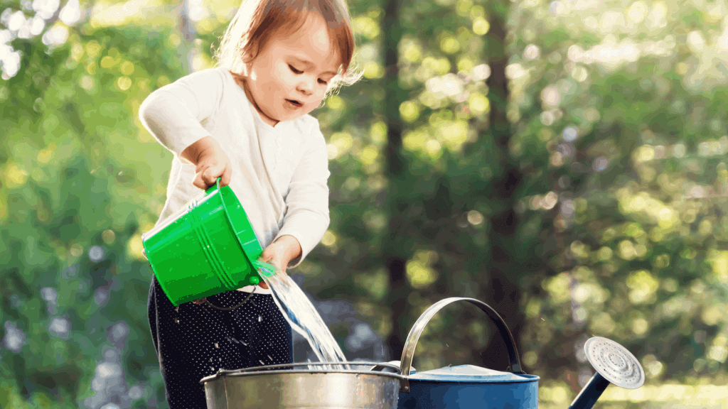 toddler with watering can