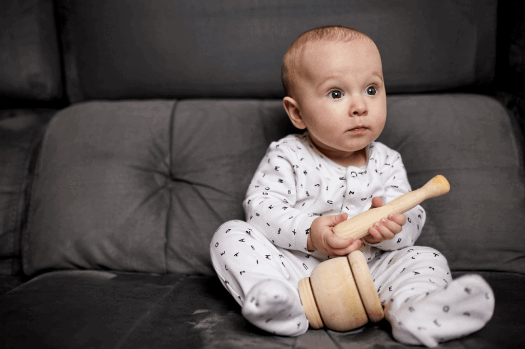 baby playing with wooden toy