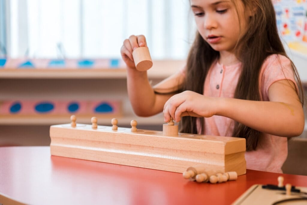 child playing in Montessori school