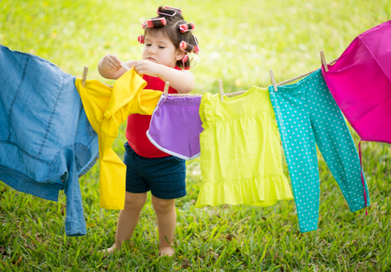 Toddler hanging clothes