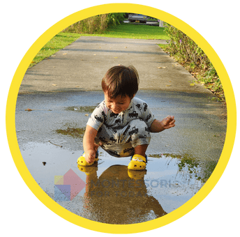 Boy playing in a puddle